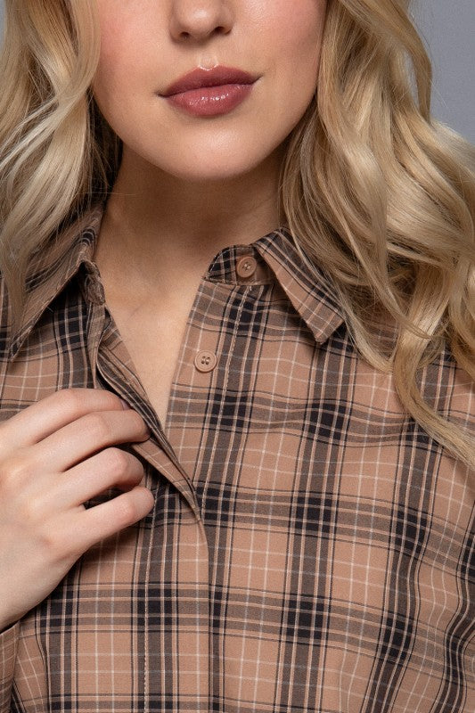 Beige tartan plaid shirt close-up showing the collar and button front.