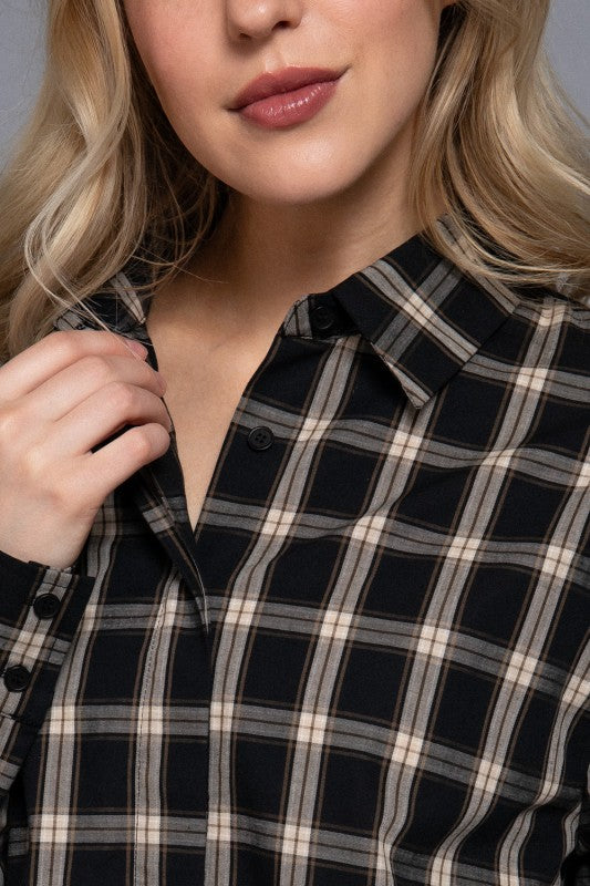 Black tartan plaid shirt close-up showing the collar and button front.