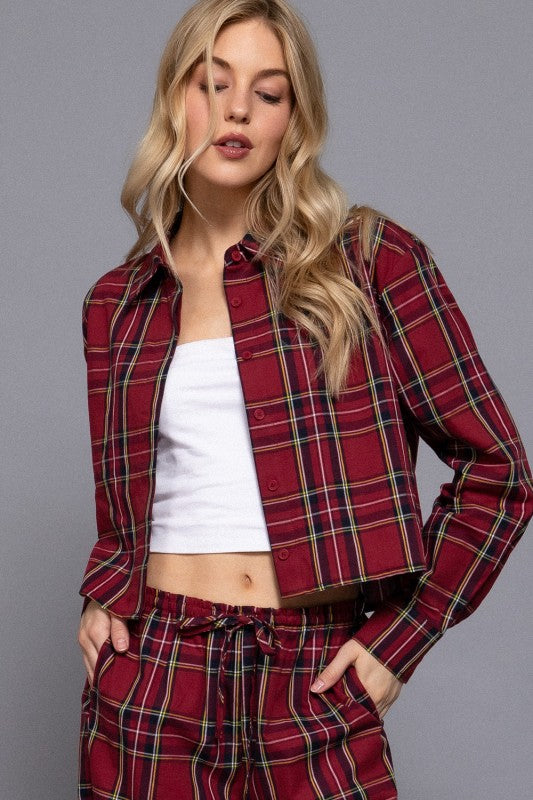 Red tartan plaid cropped shirt worn open over a white top, with matching pants.