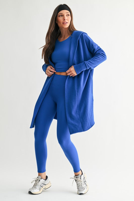Bold cobalt monochrome three piece legging bra tank cardigan active set.