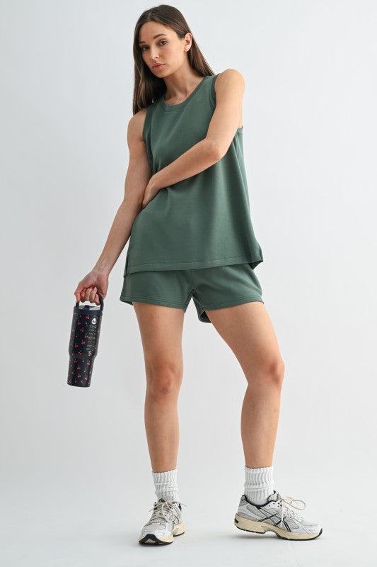 Muted green sleeveless crewneck top and matching short set with premium back and side detailing.