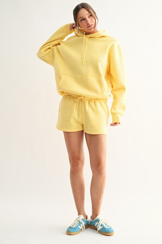 Radiant yellow matching kangaroo hoodie and pocketed short set.